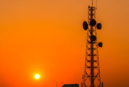Telecommunication tower structure with sunset sky in silhouette background
